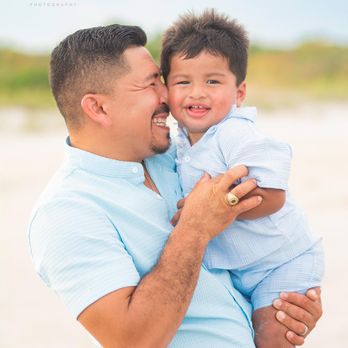 Something Like Life Photography & design - Father and son smiling together during a Myrtle Beach family photography session at sunset, standing on the beach along the South Carolina. - Session Photography Near Me Something Like Life Photography & design - Father and son smiling together during a Myrtle Beach family photography session at sunset, standing on the beach along the South Carolina. - Session Photography Near Me