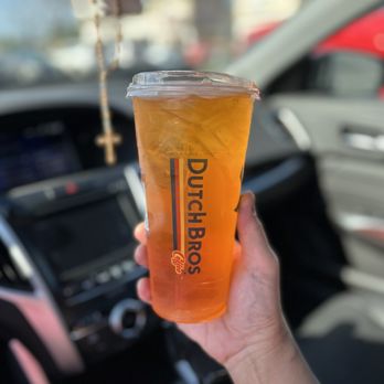 Dutch Bros Coffee - a hand holding a cup of iced coffee - Coffee & Tea Near Me - Sacramento, California Dutch Bros Coffee - a hand holding a cup of iced coffee - Coffee & Tea Near Me - Sacramento, California