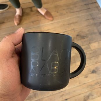 Black Rabbit Coffee - a person holding a black mug - Coffee Roasteries Near Me - Hillsboro, Illinois Black Rabbit Coffee - a person holding a black mug - Coffee Roasteries Near Me - Hillsboro, Illinois