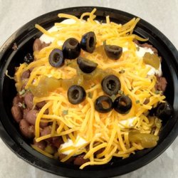 Grandmas Bluegrass Kitchen - Holy Moly chili is Grandmas chili topped with cheese, sour cream, olives, onions, and green chilies all over corn chips.