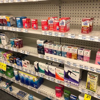 CVS Pharmacy - the shelves of a pharmacy store - The image shows an aisle in CVS Pharmacy with mostly empty shelves. There are some eye care products such as eye drops, eye masks, and related medications visible on the shelves. Price tags are displayed below the products, and the overall scene indicates a low stock of items in this section. - Pharmacy Near Me - Ottawa, Illinois