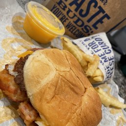 Single butter burger with cheddar and bacon. Fries and cheese sauce. Single butter burger with cheddar and bacon. Fries and cheese sauce.