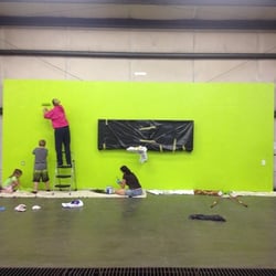 CrossFit Clarksville - Coach Allie and her little helpers painting out the information wall with WODIFY TVs installed!