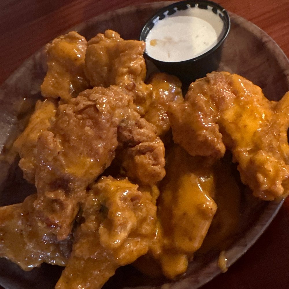 a plate of chicken wings with a side of ranch dip a plate of chicken wings with a side of ranch dip