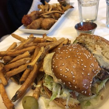 Harry & Izzy's - Steakburger (with a bite missing, sliced in half). Kids meals in the background. - Steakhouses Near Me - Indianapolis, Indiana Harry & Izzy's - Steakburger (with a bite missing, sliced in half). Kids meals in the background. - Steakhouses Near Me - Indianapolis, Indiana