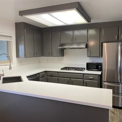 Post Construction Cleaning Pros - The kitchen after they came through. Spotless (including refrigerator interior, sink and cooktop)