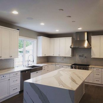 Bomterra Flooring - a kitchen with white cabinets - Flooring Near Me