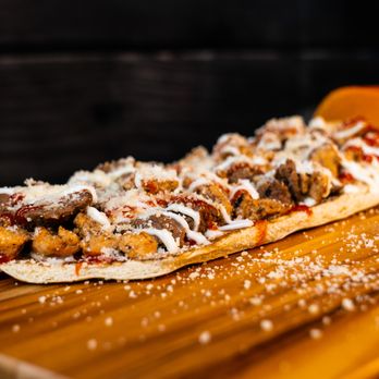 Barao’s Grill - a pizza on a cutting board - Food Trucks Near Me - Orlando, Florida Barao’s Grill - a pizza on a cutting board - Food Trucks Near Me - Orlando, Florida
