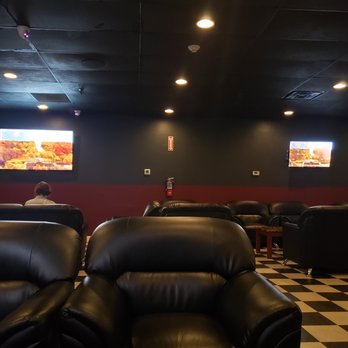 Fog It Up - a man sitting in a theater - Hookah Bars Near Me - Edison, New Jersey