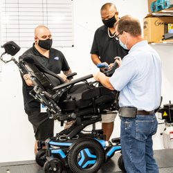 Gammie Homecare - Rush, ATP, along with Rehab Techs Daniel and Ben working on a Complex Rehab Group 3 power chair.