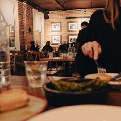 Perro Negro Taperia - Guests enjoying Spanish tapas and small plates inside Perro Negro Taperia, a cozy tapas bar in Victoria known for authentic S...