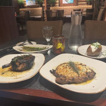 Michael's Tavern & Steakhouse - Pork chop, ribeye with crusted blue cheese, loaded baked potato and asparagus - Steakhouses Near Me - Indian River, Michigan Michael's Tavern & Steakhouse - Pork chop, ribeye with crusted blue cheese, loaded baked potato and asparagus - Steakhouses Near Me - Indian River, Michigan