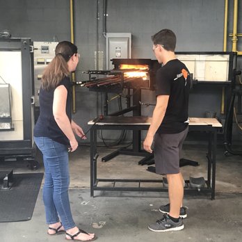 Hollywood Hot Glass - Rolling the original molten glass into a cylinder. - Art Galleries Near Me - Hollywood, Florida Hollywood Hot Glass - Rolling the original molten glass into a cylinder. - Art Galleries Near Me - Hollywood, Florida