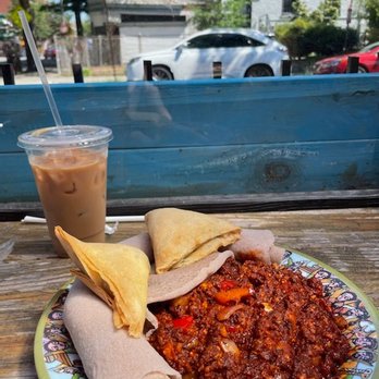 Heat Da Spot - Behold, the breakfast to end all breakfasts. Ethiopian breakfast dish with two lentil samosas and iced coffee with oat milk - Coffee & Tea Near Me - Washington, DC, District of Columbia