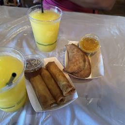 Mango margaritas and seafood egg rolls and crawfish empanadas Mango margaritas and seafood egg rolls and crawfish empanadas