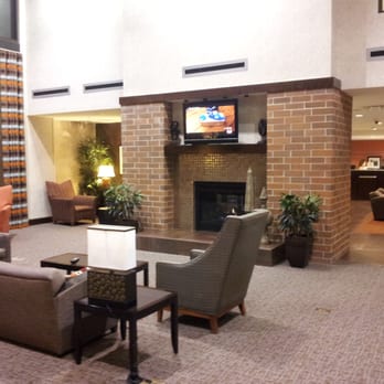 Hampton Inn & Suites Omaha-Downtown - Lounge by the fireplace - Hotels Near Me - Omaha, Nebraska Hampton Inn & Suites Omaha-Downtown - Lounge by the fireplace - Hotels Near Me - Omaha, Nebraska