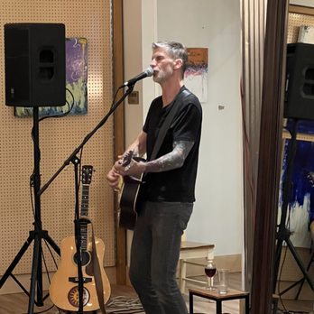 Borelli Cellars - a man playing a guitar and singing into a microphone - Wineries Near Me - Pittsburgh, Pennsylvania