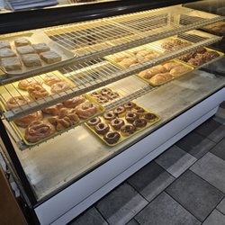 Missy's Donuts - Display case with Missy's donuts, fried  cinnamon rolls and other treats.