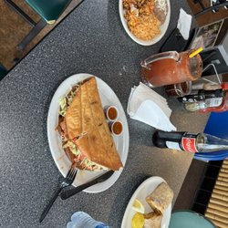 Tacos Ensenada - Michelada, Chilaquiles with rice and beans plate, flour taco and breakfast burrito.