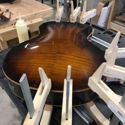 Brooks Acoustic and Guitar Restoration, LLC - Re-gluing a guitar.