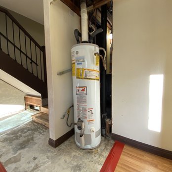 Cooper Environmental - Removed drywall behind the water heater - Environmental Abatement Near Me