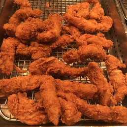 a close up of a fried chicken in a deep fryer