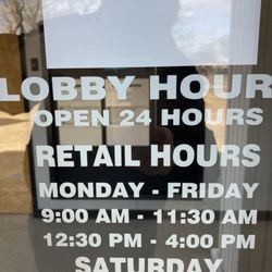 U.S. Postal Service - Hughes - hours posted next to front entrance