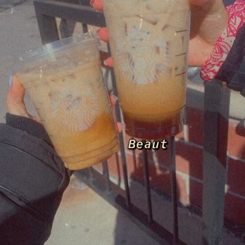 Starbucks - a person holding two cups of iced coffee - Coffee & Tea Near Me - Oakville, Ontario Starbucks - a person holding two cups of iced coffee - Coffee & Tea Near Me - Oakville, Ontario