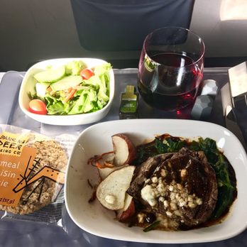 Delta Air Lines - Dinner: Beef with gravy over spinach, onions, and potatoes; side salad with balsamic vinaigrette; and "the cookie." - Airlines Near Me - Hebron, Kentucky