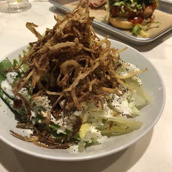 Nomad Eatery - Yes, there is a salad under all of those delicious crispy onions. - New American Near Me - South Jordan, Utah Nomad Eatery - Yes, there is a salad under all of those delicious crispy onions. - New American Near Me - South Jordan, Utah