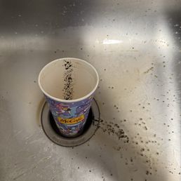 McCafé coffee cup with coffee grounds.