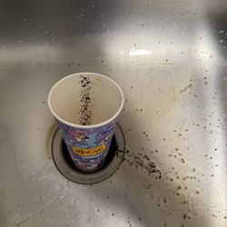 McCafé coffee cup with coffee grounds.