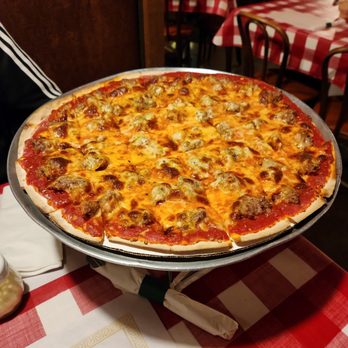 Frank's Pizzeria - a pizza on a serving tray - Pizza Near Me - Chicago, Illinois Frank's Pizzeria - a pizza on a serving tray - Pizza Near Me - Chicago, Illinois