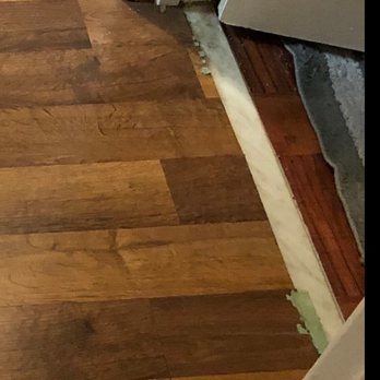Empire Today - Ripped up Spacer (installer ripped it up) between bathroom and hallway where floor is coming up. - Carpet Installation Near Me