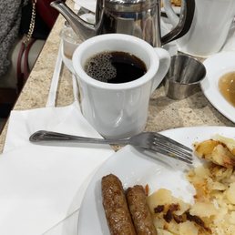 a plate of food and a cup of coffee