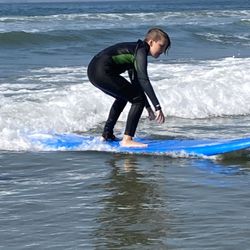 Surfriders Academy Surf School - Student first time surfing 
in Huntington Beach.