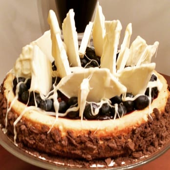 Cakes By Hollis - White Chocolate Cheesecake w / Fresh Blueberry Glasee, Fresh Blueberries and White Chocolate Barks and Drizzle. - Desserts Near Me Cakes By Hollis - White Chocolate Cheesecake w / Fresh Blueberry Glasee, Fresh Blueberries and White Chocolate Barks and Drizzle. - Desserts Near Me