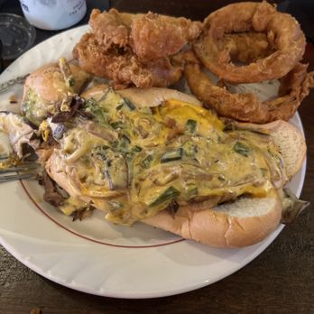 Hillcrest Tavern - Philly cheese steak with onion rings. - American Near Me - Louisville, Kentucky