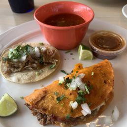 Quesabirria taco with consommé and carne asada taco.
