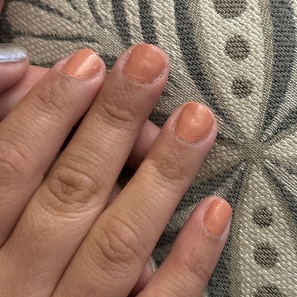 Clear polish not even all the way by the cuticle. (Color of nail makes it hard photograph)