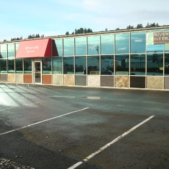 Riverside Interiors - an empty parking lot with a red awning - Carpeting Near Me - Pacific, Washington Riverside Interiors - an empty parking lot with a red awning - Carpeting Near Me - Pacific, Washington