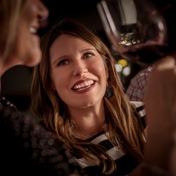 The Wine Authority - a woman laughing with friends - Wine Tasting Room Near Me - Richardson, Texas