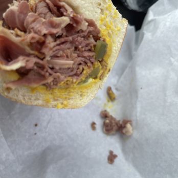 The Deli - a person holding a sandwich in their hand - Delis Near Me - Sandwich, Massachusetts The Deli - a person holding a sandwich in their hand - Delis Near Me - Sandwich, Massachusetts
