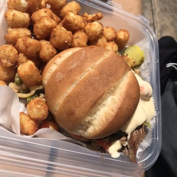 Dells Distillery - a sandwich and tater tots in a plastic container - New American Near Me - Wisconsin Dells, Wisconsin