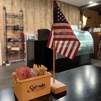 Rodney's Bar-B-Que And Catering - ows a small american flag on a table - Barbeque Near Me - Dallas, Georgia Rodney's Bar-B-Que And Catering - ows a small american flag on a table - Barbeque Near Me - Dallas, Georgia