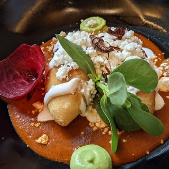 Xochi - Molote with papa and stuffed with chorizo. Light red mole and chapolinas. - Mexican Near Me - Houston, Texas