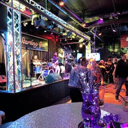 a band playing on stage at a party a band playing on stage at a party
