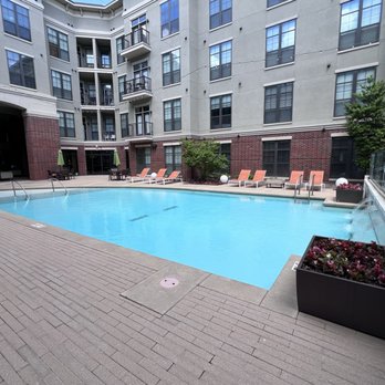 The Edge at East Village - Pool Courtyard with tanning ledge, water falls and plenty of lounge chairs - Apartments Near Me - Tulsa, Oklahoma The Edge at East Village - Pool Courtyard with tanning ledge, water falls and plenty of lounge chairs - Apartments Near Me - Tulsa, Oklahoma