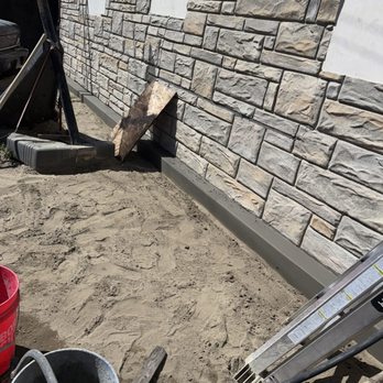Islander Concrete - Concrete curb to protect puddling/pooling at foundation. Repairs to wall in progress at time of photo. - Masonry/Concrete Near Me Islander Concrete - Concrete curb to protect puddling/pooling at foundation. Repairs to wall in progress at time of photo. - Masonry/Concrete Near Me