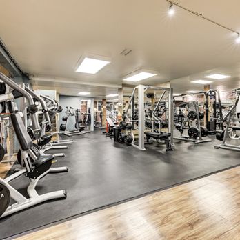 The Seattle Gym - A view of the large strength weight room floor featuring 4 squat racks, Smith machine and other machines - Gyms Near Me - Seattle, Washington The Seattle Gym - A view of the large strength weight room floor featuring 4 squat racks, Smith machine and other machines - Gyms Near Me - Seattle, Washington